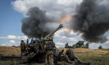 Ukrainian service members fire a shell from a towed howitzer FH-70 at a front line