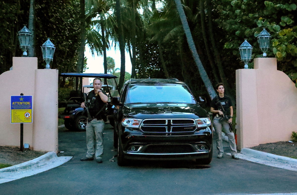<i>Damon Higgins/AP</i><br/>Secret Service agents stand at the gate of Mar-a-Lago after the FBI issued warrants at the Palm Beach
