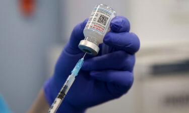 A health worker draws the Moderna Covid-19 vaccine as she prepares to administer the spring booster also known as fourth jab to a person at a vaccination clinic.