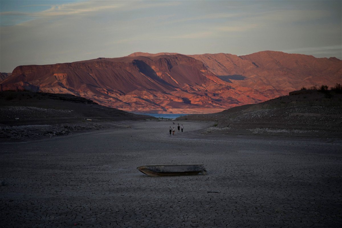 <i>John Locher/AP</i><br/>A formerly sunken boat sits on the dry lake bed of Lake Mead in May.