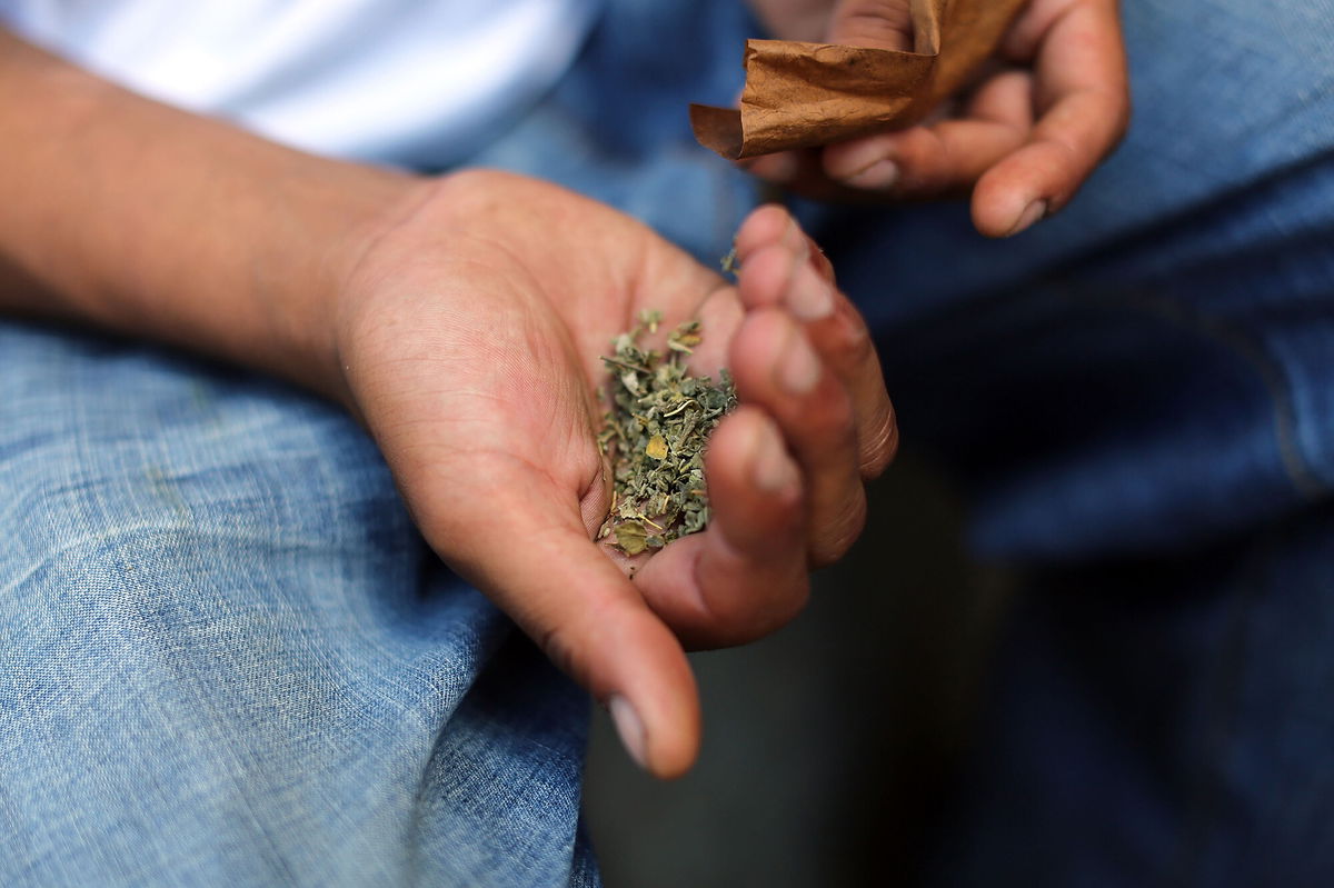 <i>Spencer Platt/Getty Images</i><br/>A man prepares to smoke K2 or 