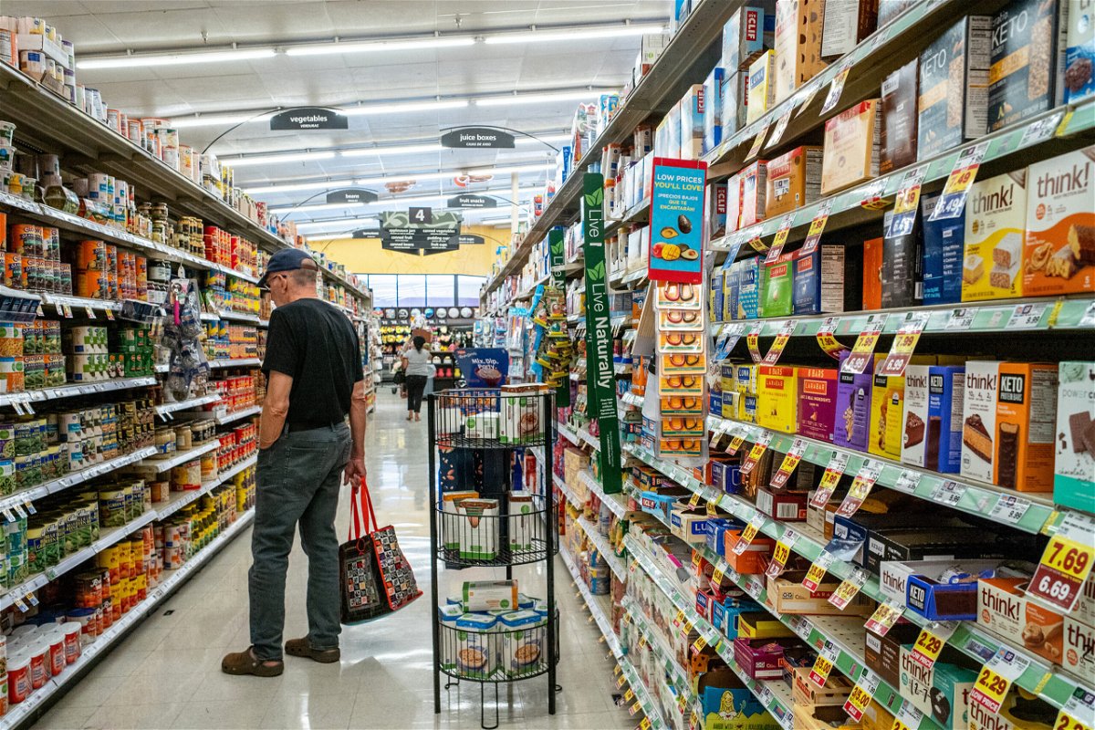 <i>Brandon Bell/Getty Images</i><br/>A customer shops in a Kroger grocery store on July 15 in Houston. Month-over-month inflation in the US eased in July