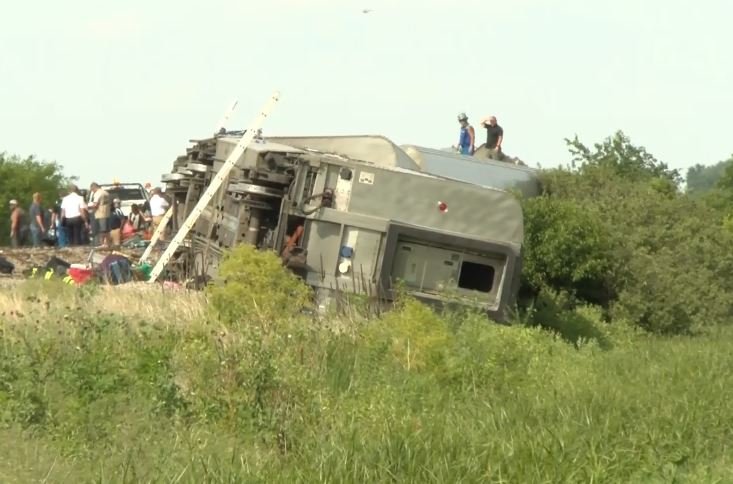 FILE - Derailed train cars sit along a track near Mendon, Missouri, after an Amtrak crash.