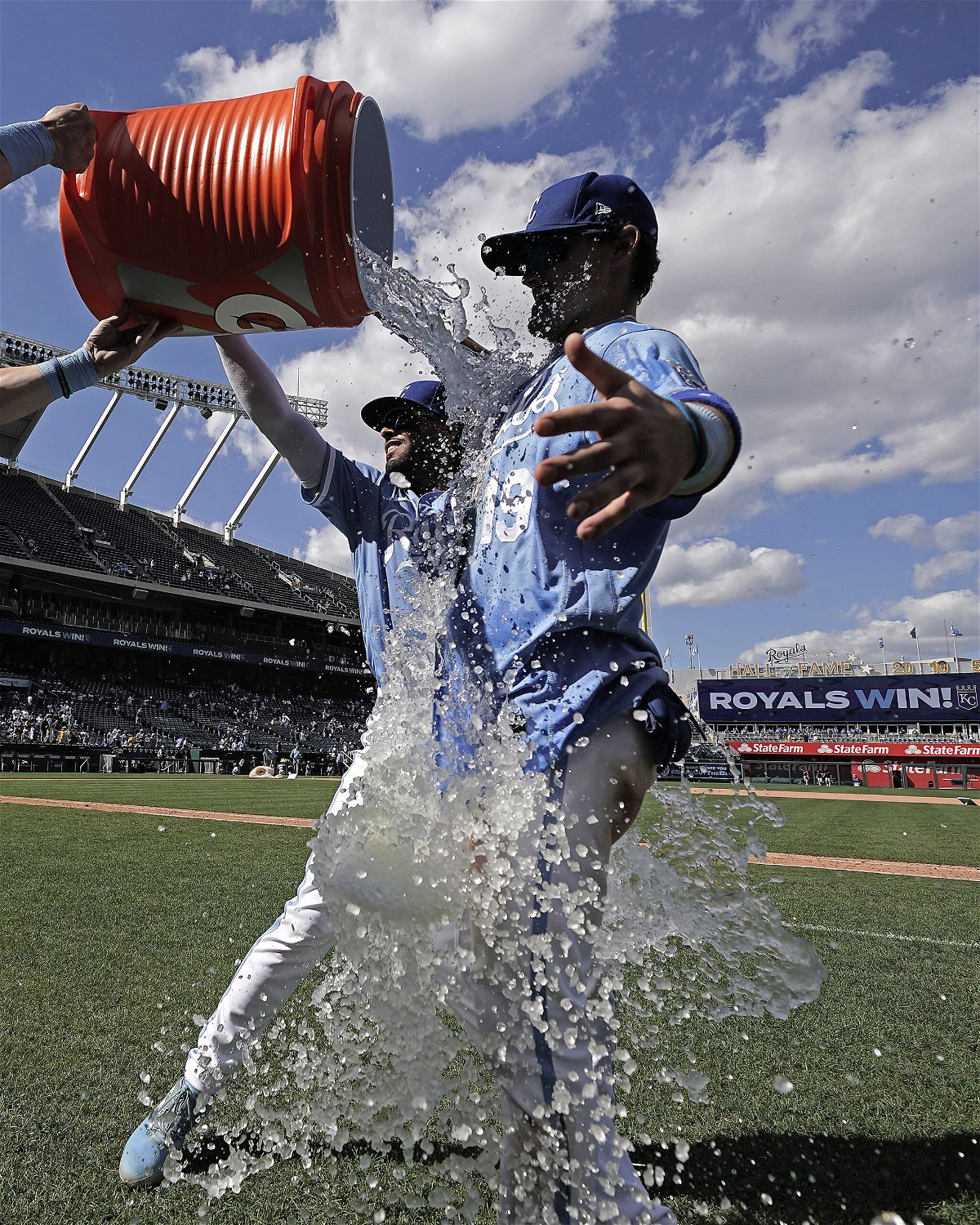 Kansas City Royals' Michael Massey (19) is doused by MJ Melendez and Bobby Witt Jr., left, after their baseball game against the Detroit Tigers Sunday, Sept. 11, 2022, in Kansas City, Mo. The Royals won 4-0. (AP Photo/Charlie Riedel)