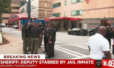 Police stand outside Grady Memorial Hospital where the injured deputy is being treated.
