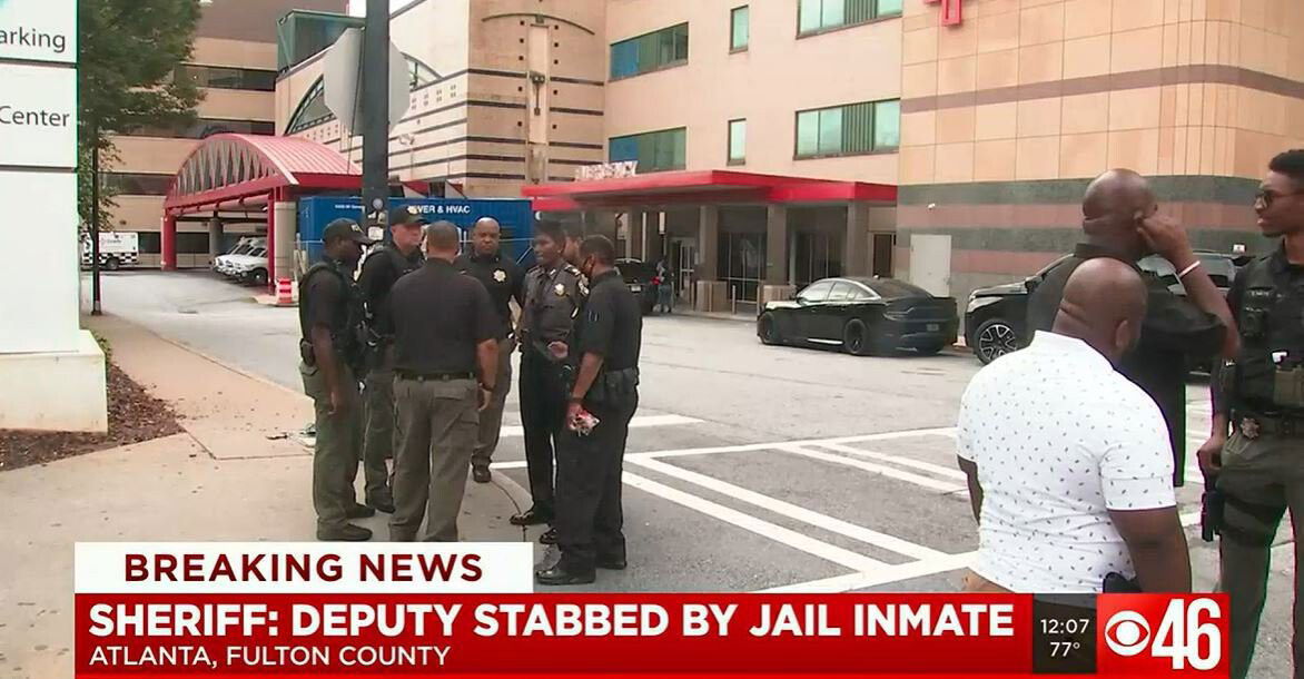 <i>WGCL</i><br/>Police stand outside Grady Memorial Hospital where the injured deputy is being treated.