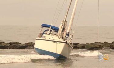 The boat got stuck in the sand after washing ashore near 9th Street Beach early Monday morning.