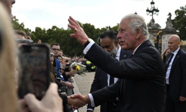 King Charles III greets mourners as he arrives at Buckingham Palace in London