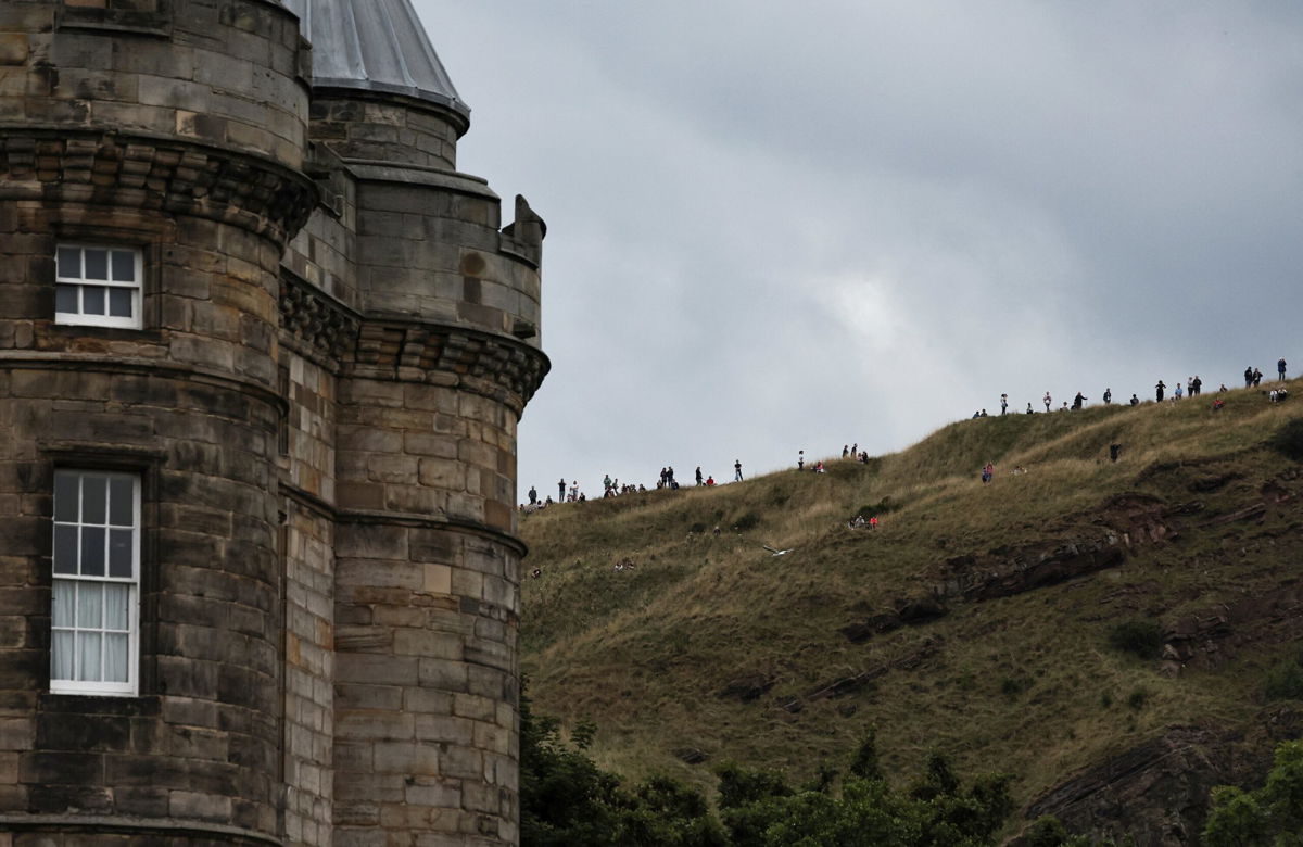 <i>Alkis Konstantinidis/Reuters</i><br/>People wait for the hearse's arrival in Edinburgh.