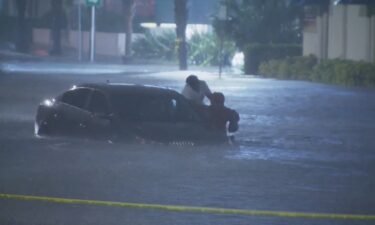 WESH reporter Tony Atkins rescues woman from her car that was stuck in flood waters from Hurricane Ian.