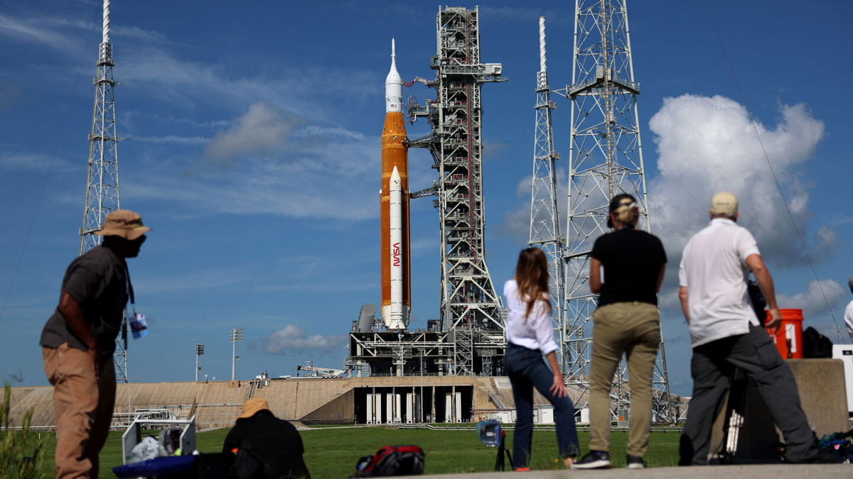 <i>Joe Raedle/Getty Images</i><br/>Photographers and reporters work near NASA's Artemis I rocket at Kennedy Space Center on August 29. A range of issues prevented liftoff then.