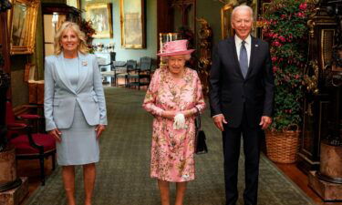 Queen Elizabeth II (C) with US President Joe Biden and First Lady Jill Biden in the Grand Corridor during their visit to Windsor Castle on June 13