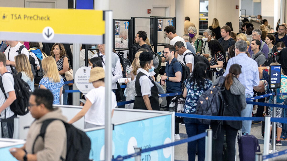 <i>Jeenah Moon/Getty Images</i><br/>Travelers line up to enter a security checkpoint at Newark Liberty International Airport on July 1.