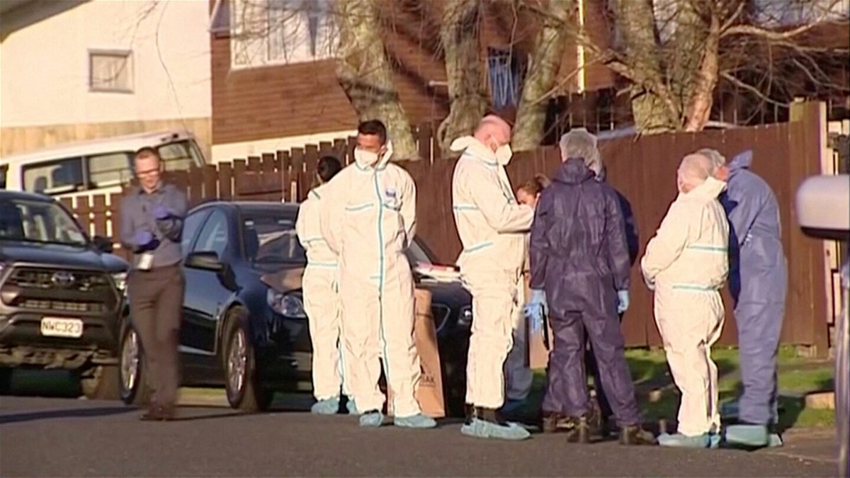 <i>TVNZ/Reuters</i><br/>Police and forensic investigators gather at the scene where suitcases with the remains of two children were found in Auckland