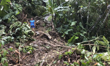 Nancy Galarza looks at the damage Hurricane Fiona inflicted on her rural community of San Salvador in the town of Caguas