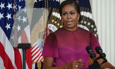 Former US First Lady Michelle Obama delivers remarks during a ceremony to unveil their official White House portraits