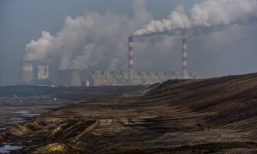Steam and smoke rises from the Belchatow Power Station is pictured from a viewing point over the open-pit coal mine on February 23