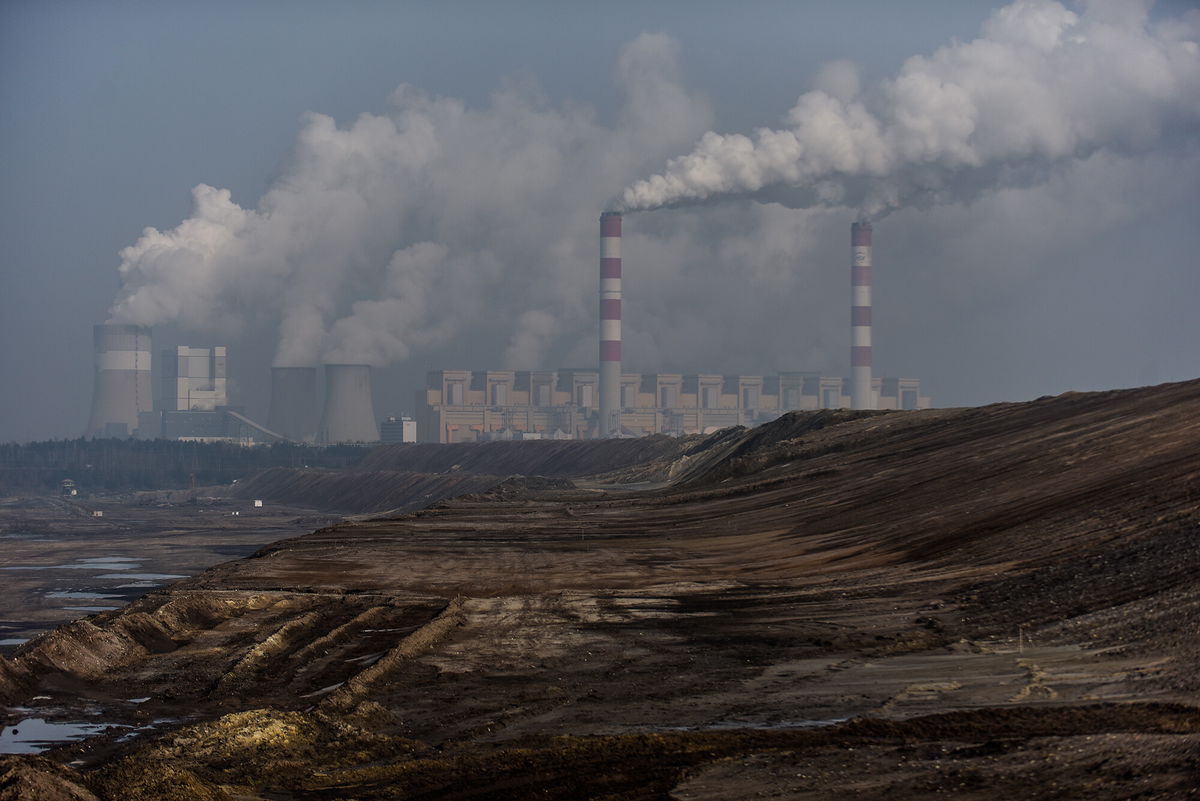 <i>Omar Marques/Getty Images</i><br/>Steam and smoke rises from the Belchatow Power Station is pictured from a viewing point over the open-pit coal mine on February 23