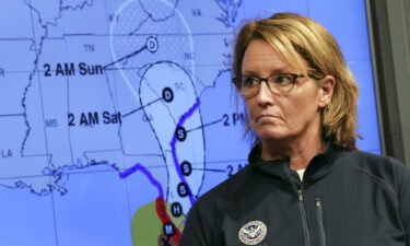 Federal Emergency Management Agency administrator Deanne Criswell stands next to a track map of Hurricane Ian during a news conference at FEMA headquarters on September 28
