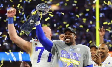 Von Miller holds up the Vince Lombardi Trophy after winning Super Bowl LVI.