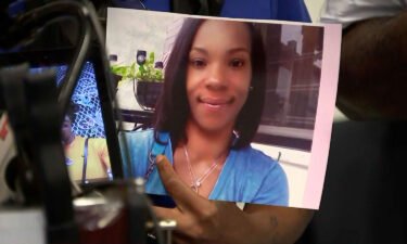 A family member holds an image of Tiffany Fletcher at a news conference on September 12. A 14-year-old boy has been charged with murder in connection with the shooting death of Fletcher.