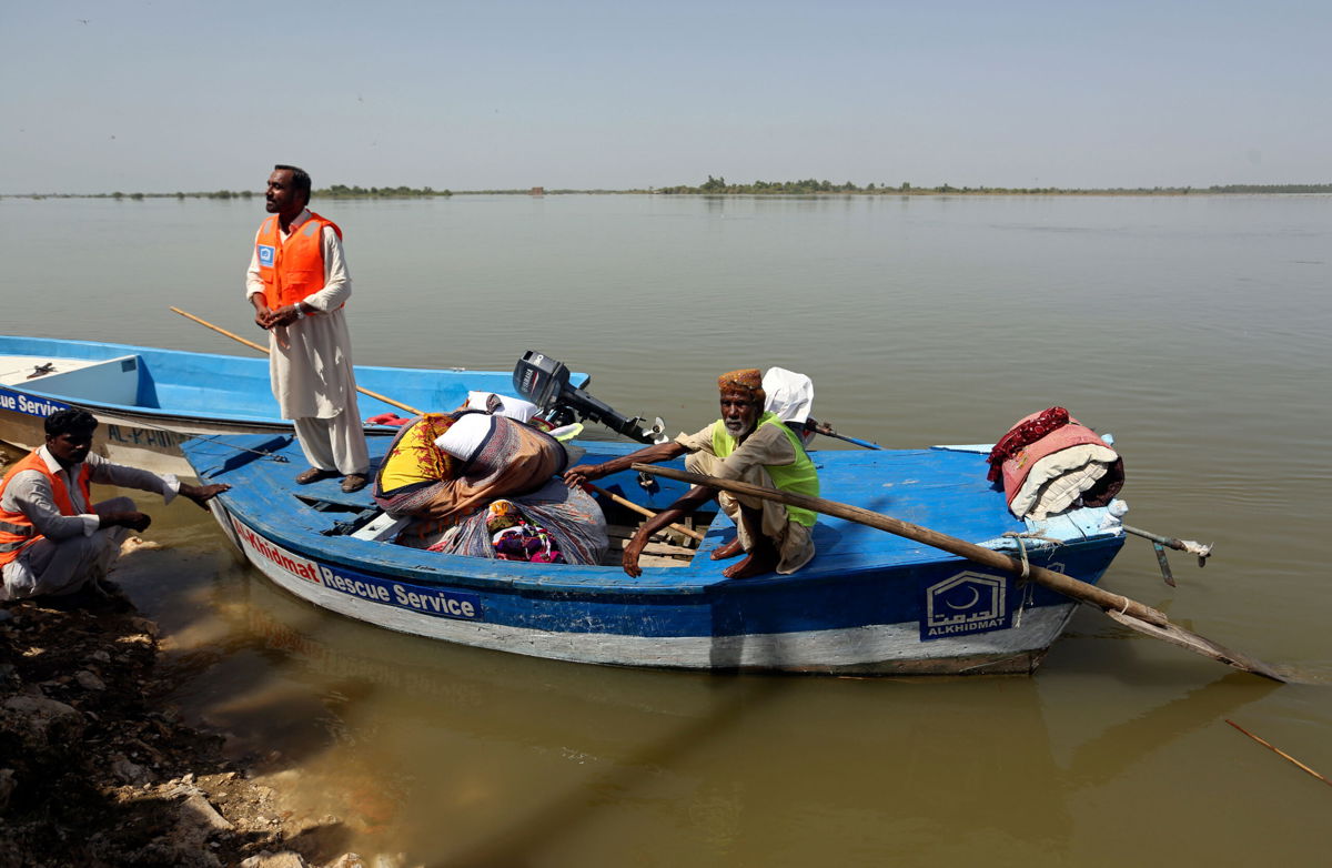 <i>Fareed Khan/AP</i><br/>Flood victims are seen here receiving relief aid in Sindh province's Sukkur city on the Indus River on September 4. Authorities in Pakistan have warned it could take up to six months for deadly flood waters to recede in the country's hardest-hit areas.