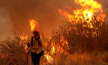 A firefighter battles the Fairview Fire on September 6. The fire has now charred more than 7