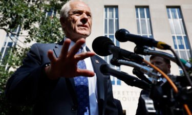 Former Trump White House adviser Peter Navarro talks briefly with reporters on August 31 in Washington