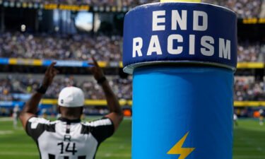 An "End Racism" sign is shown on a goal post during an NFL game on September 11. Black NFL head coaches regularly perform about as well as White NFL head coaches yet face significant hurdles to getting and keeping their jobs.