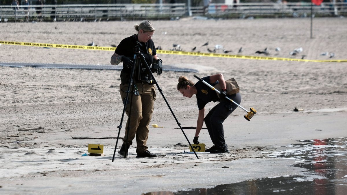 <i>Spencer Platt/Getty Images</i><br/>The 30-year-old mother who allegedly drowned her three children off Coney Island in New York City was arraigned September 16 on charges of first-degree murder. Police are pictured here working where the children were found on the shoreline.