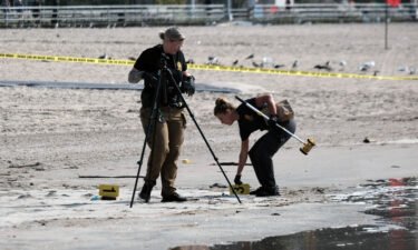 The 30-year-old mother who allegedly drowned her three children off Coney Island in New York City was arraigned September 16 on charges of first-degree murder. Police are pictured here working where the children were found on the shoreline.