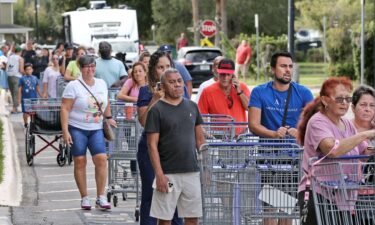Shoppers wait in line on September 25 as people rush to prepare for Hurricane Ian in Kissimmee