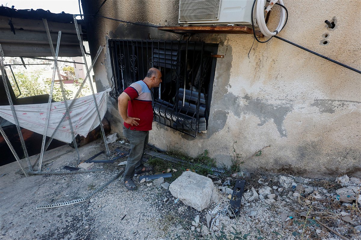 <i>Raneen Sawafta/Reuters</i><br/>A Palestinian man checks for damage after an Israeli raid in Jenin on September 28.