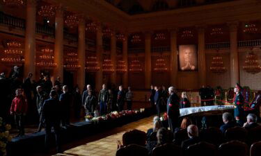 People walk past the coffin of former Soviet President Mikhail Gorbachev inside the Pillar Hall of the House of the Unions during a farewell ceremony in Moscow