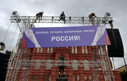 The US is imposing "swift and severe costs" on Russia after President Vladimir Putin announced the annexation of regions of Ukraine. Workers fix a banner reading "Donetsk