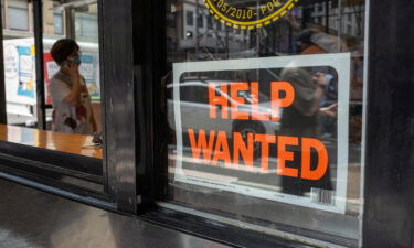 A "help wanted" sign is displayed in a window in Manhattan on July 28 in New York City.