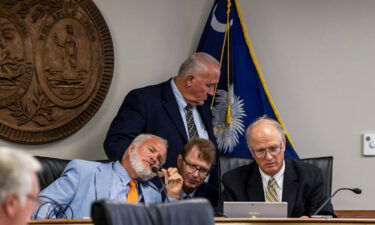 Medical Affairs Committee Chair Daniel B. "Danny" Verdin III and research director Gene Hogan listen to Sen. Richard J. Cash during a debate on the abortion bill in Columbia