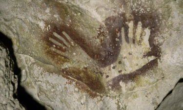 Hand stencils were found in the cave where the amputated skeleton was discovered.