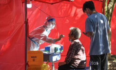 A medical worker takes a swab sample from a resident for nucleic acid test at a community testing site for Covid-19 in Yunyan District of Guiyang