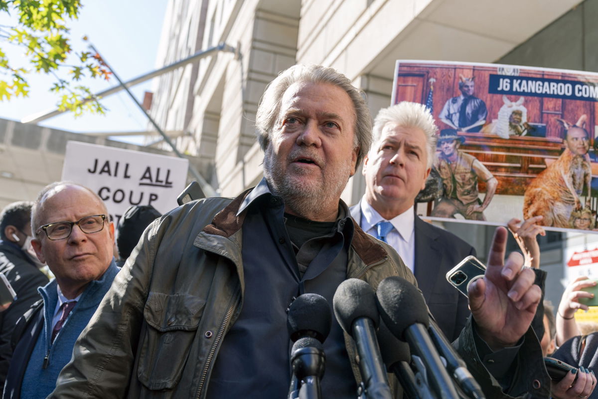 Steve Bannon a longtime ally of former President Donald Trump and convicted of contempt of Congress, accompanied by his attorney Evan Corcoran, right, speaks to the media as he leaves the federal courthouse on Friday, Oct. 21, 2022, in Washington. Bannon was sentenced to 4 months behind bars for defying a Jan. 6 committee subpoena. 