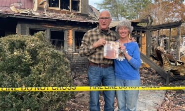 The Farm owners Beverly (right) and Myron Gottfried found one of their wedding photos while looking through the remains of their property after a Saturday fire.