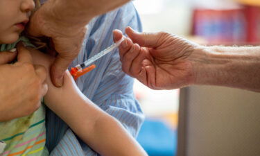 A young child receives a Moderna Covid-19 6 months to 5 years vaccination at Temple Beth Shalom in Needham