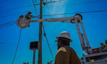 Florida Power & Light Company workers check the lines on Fort Myers Beach after Hurricane Ian.