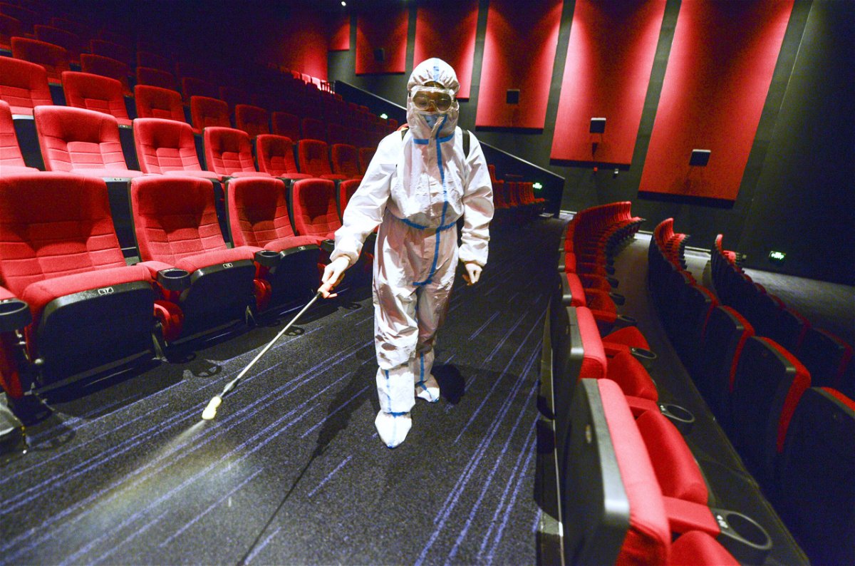<i>Liu Xin/China News Service/Getty Images</i><br/>China has banned residents from leaving Xinjiang over a Covid-19 outbreak. A worker is seen here wearing personal protective equipment disinfecting a cinema on August 9 in Urumqi