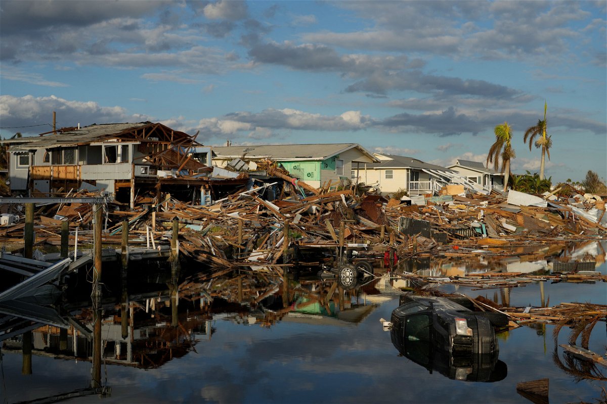 <i>Rebecca Blackwell/AP</i><br/>Cars and debris from washed away homes line a canal in Fort Myers Beach on October 5