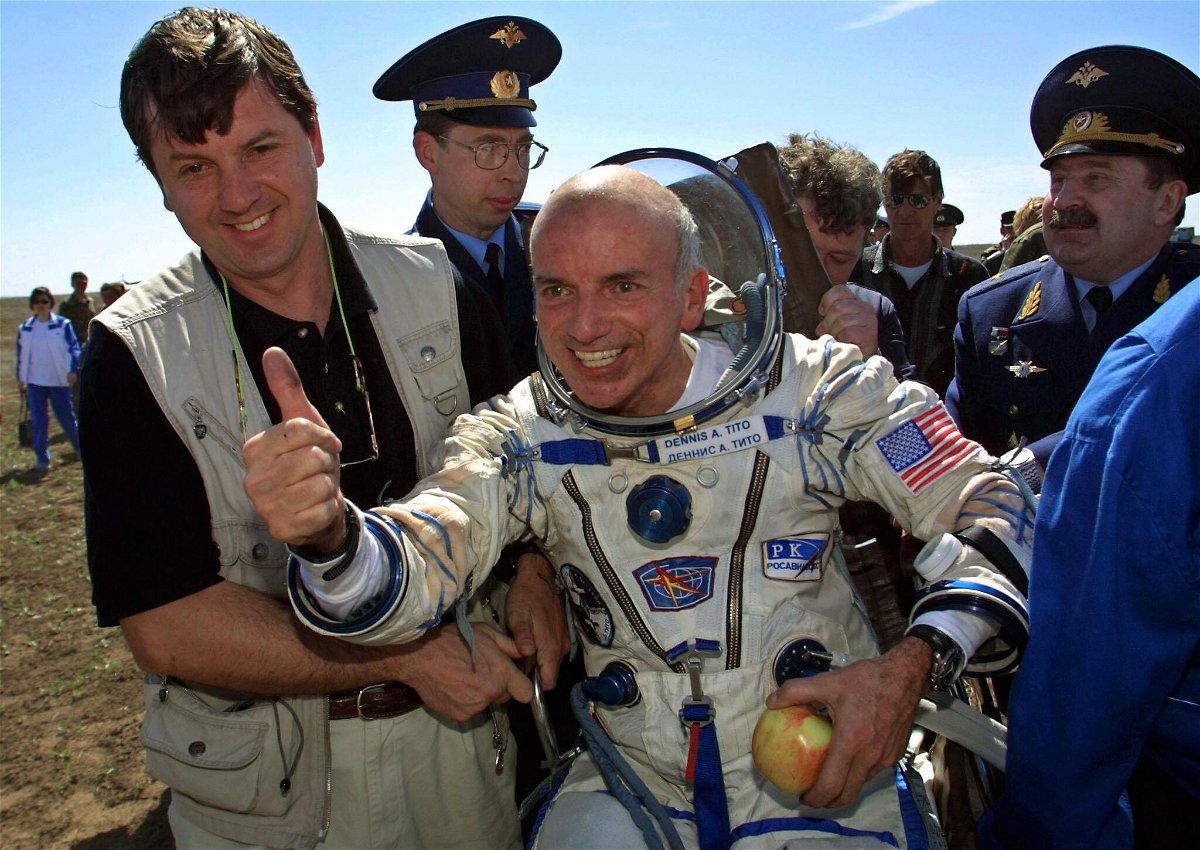 <i>Alexander Nemenov/AFP/Getty Images</i><br/>US millionaire Dennis Tito celebrates after landing near the Kazakh town of Arkalyk following his trip as the world's first space tourist in 2001. SpaceX said on October 12 that it has booked yet another mission around the moon for a wealthy thrill-seeker
