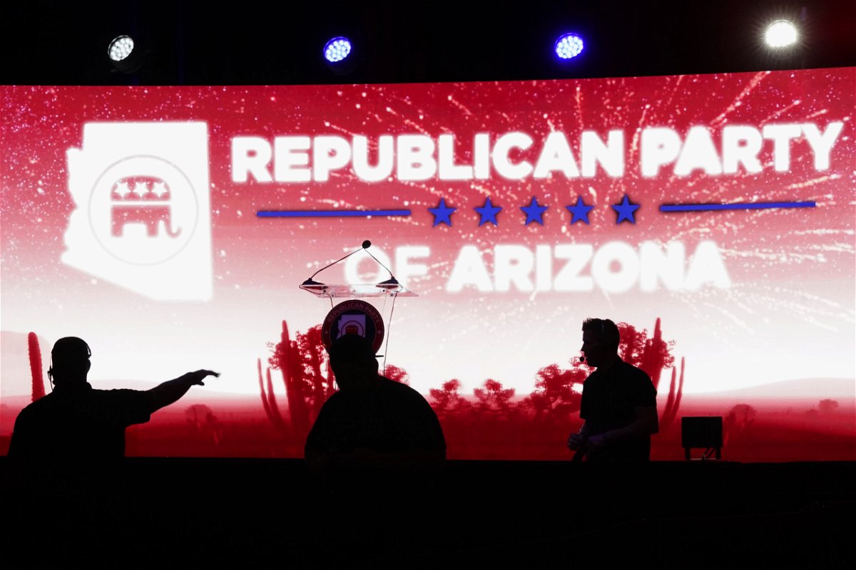 Production crew members prepare the stage at the Republican watch party in Scottsdale, Ariz., Tuesday, Nov. 8, 2022. 