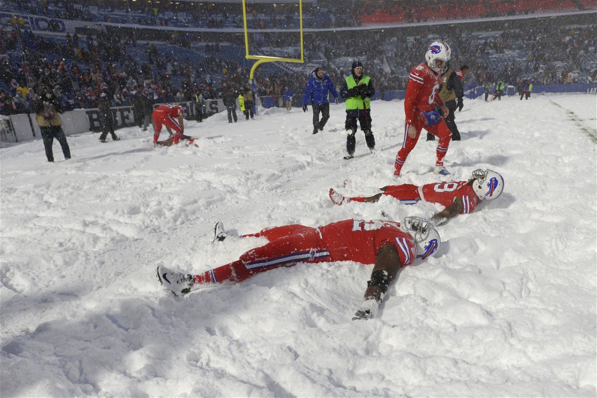 FILE - Buffalo Bills players make snow angels in the snow after defeating the Indianapolis Colts after an NFL football game, on Sunday, Dec. 10, 2017, in Orchard Park, N.Y. The NFL is monitoring the weather and has contingency plans in place in the event a lake-effect snowstorm hitting the Buffalo disrupts the Bills ability to host the Cleveland Browns on Sunday, Nov. 20, 2022.