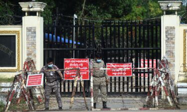 Prison security officials prepare for the reported release of inmates outside Insein prison in Yangon.