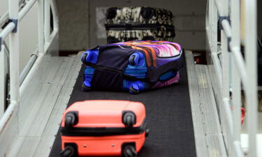 Suitcases roll onto a Sundair A320 aircraft at Dresden International Airport in Germany. Take a photograph of your luggage. It could come in handy later.